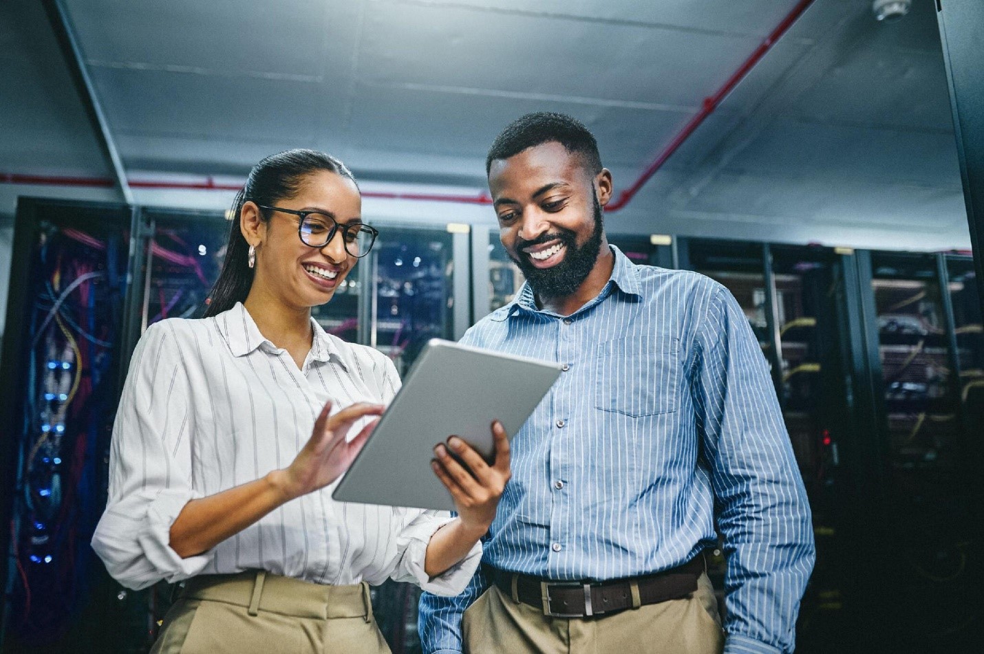 Shot of two young technicians using a digital tablet while working